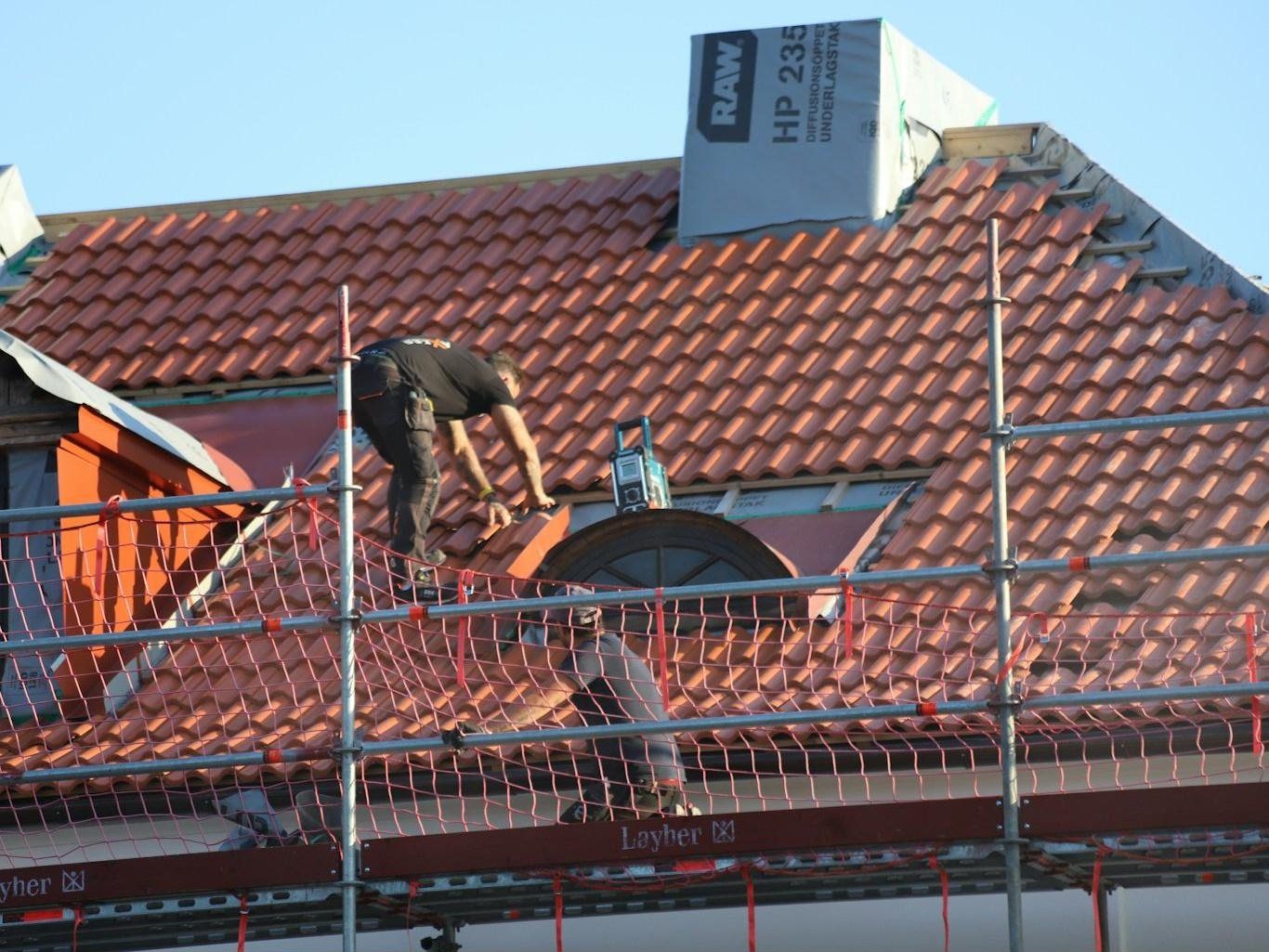 Damaged roof sheeting being repaired after a storm